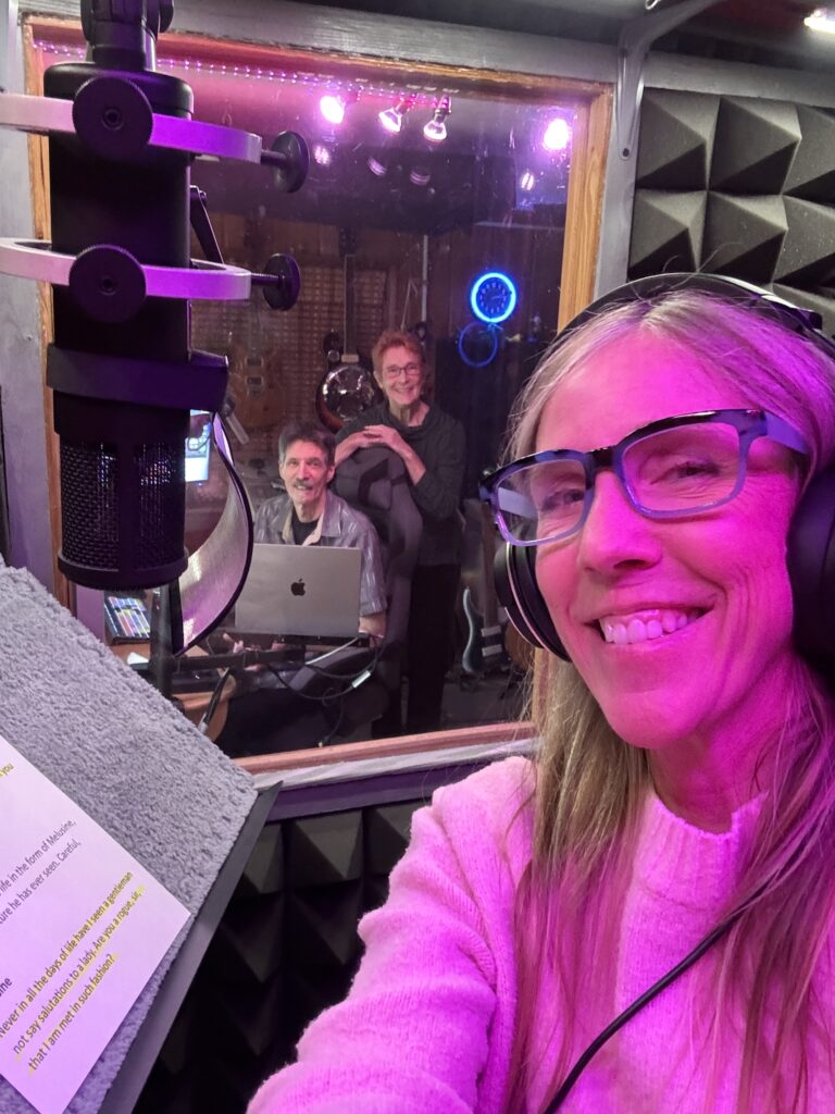 Erin Lehn in the recording booth, with Marc Rose and Jodi Lorimer in the background